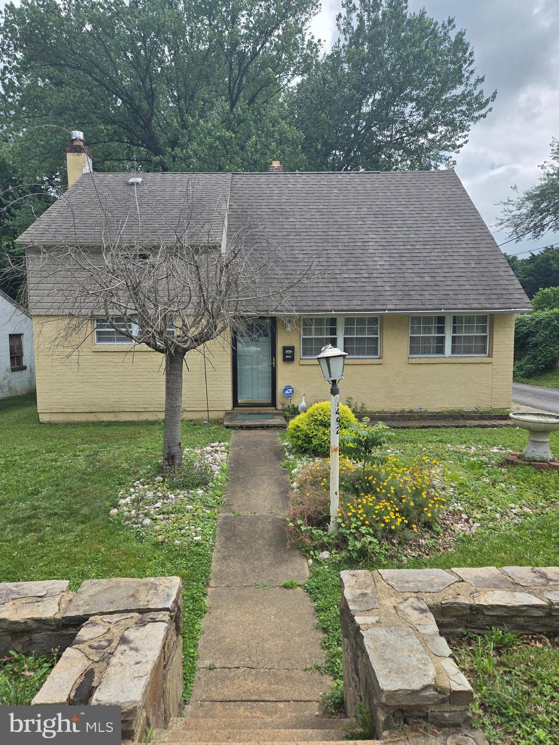 1492 Faulkland Road Wilmington, DE 19805 - Photo 1 of 23 a front view of a house with garden