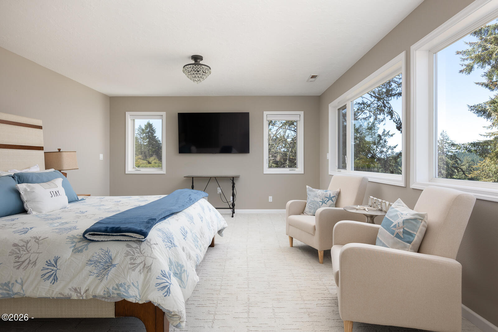 6905 Northeast Highland Road Otis, OR 97368 - Photo 29 of 76 a bedroom with a bed and a flat screen tv