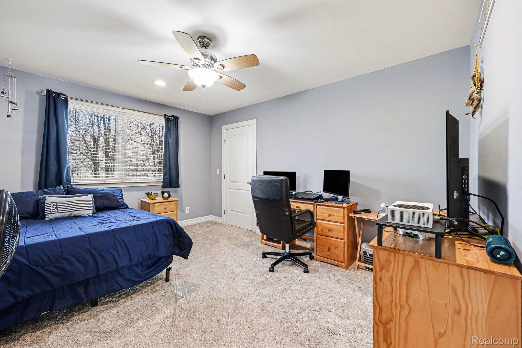 55256 Lee Road New Hudson, MI 48165 - Photo 18 of 28 Bedroom featuring light carpet, an office area, and ceiling fan