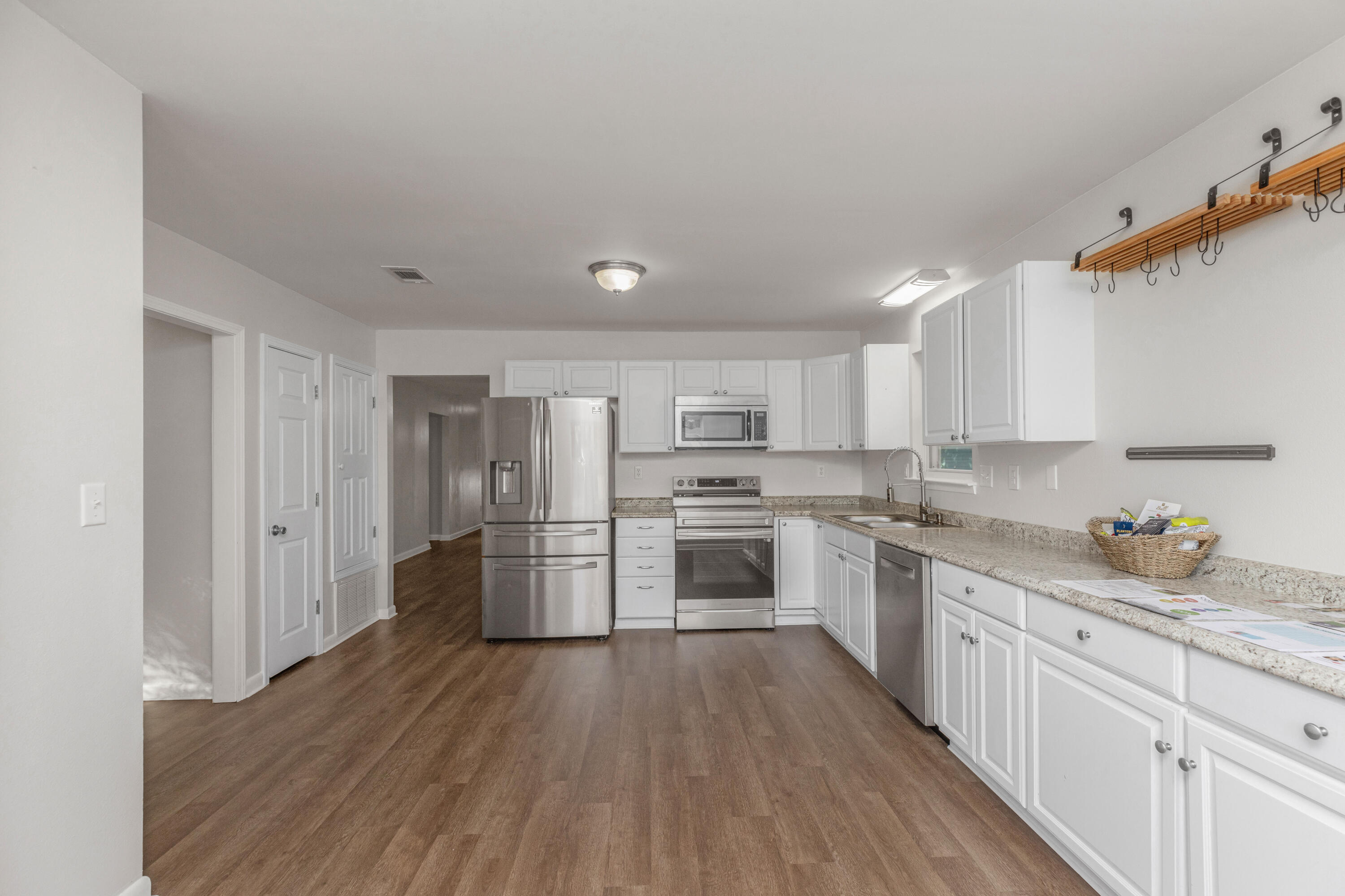 229 Madison Street Freeport, FL 32439 - Photo 12 of 44 a kitchen with a sink cabinets stainless steel appliances and a window