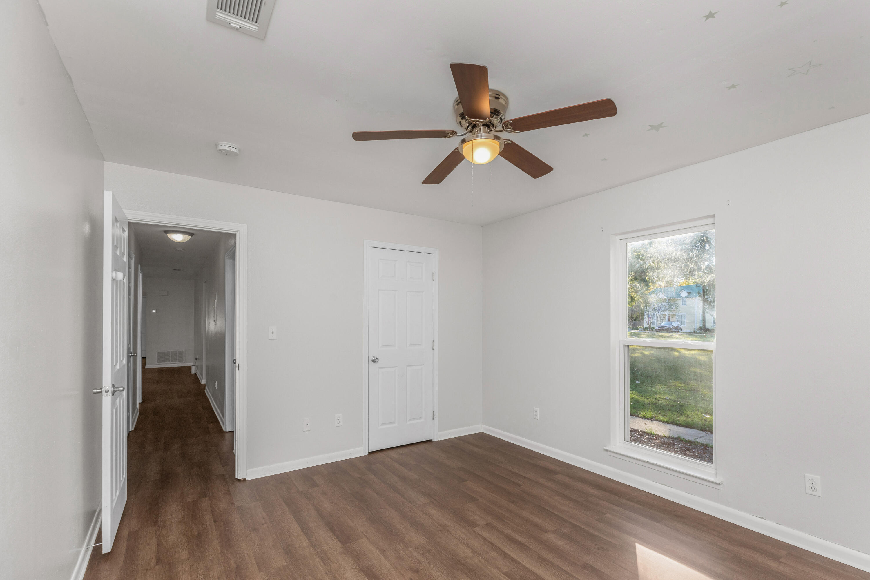 229 Madison Street Freeport, FL 32439 - Photo 24 of 44 wooden floor in an empty room with a window