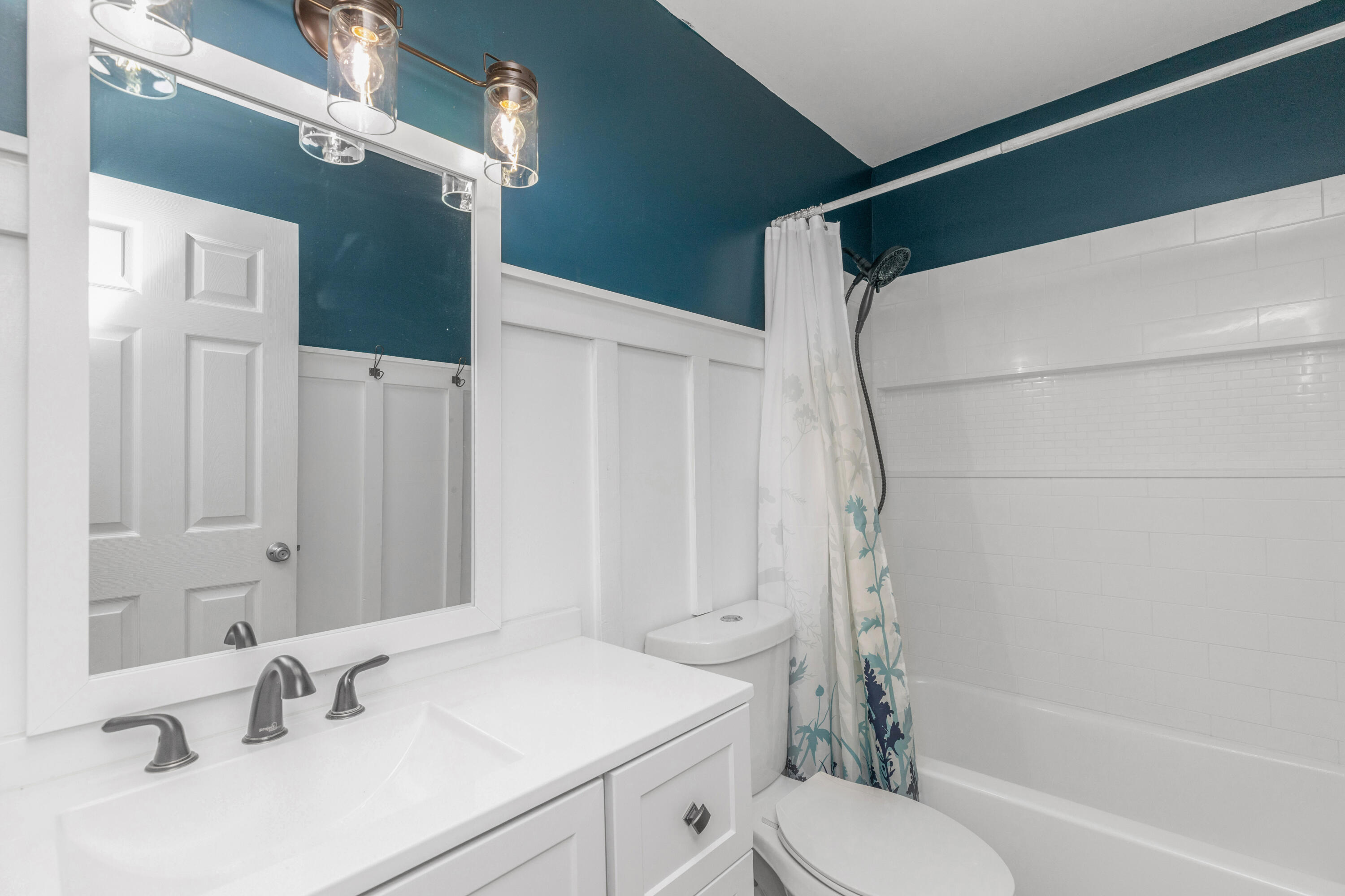 229 Madison Street Freeport, FL 32439 - Photo 26 of 44 a bathroom with a sink toilet and shower