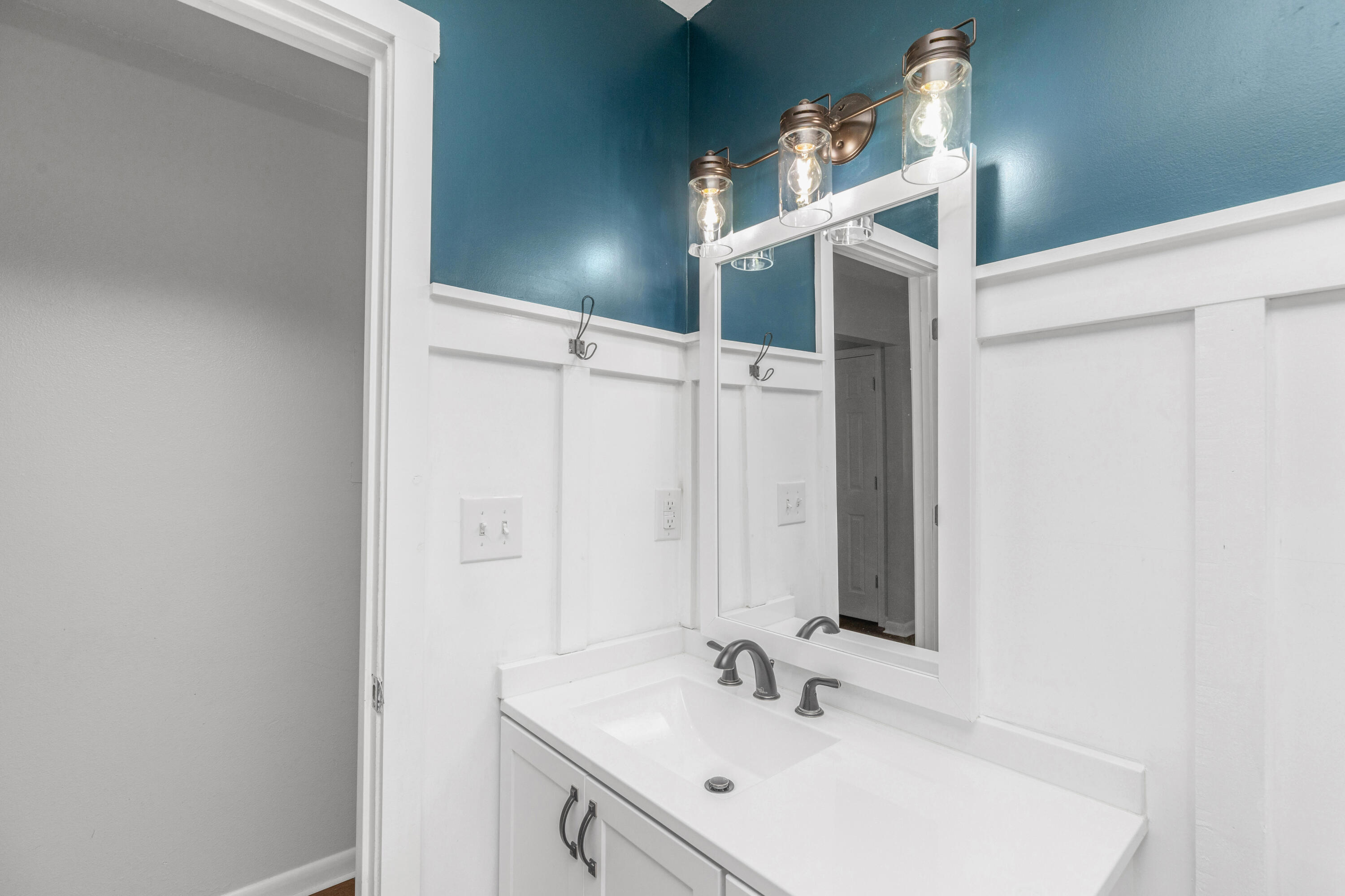 229 Madison Street Freeport, FL 32439 - Photo 27 of 44 a bathroom with a sink and a mirror