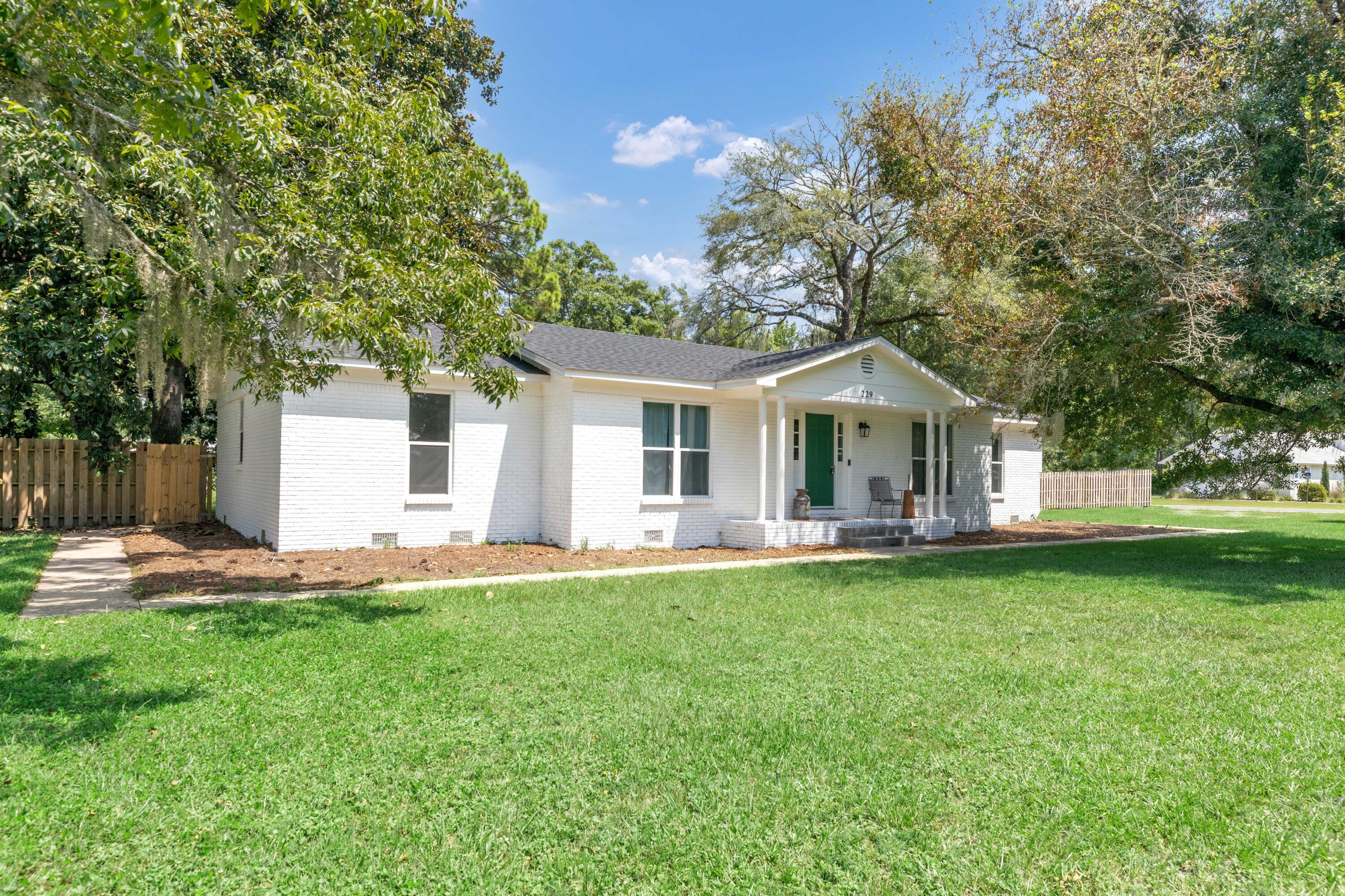 229 Madison Street Freeport, FL 32439 - Photo 3 of 44 a front view of house with yard and outdoor seating