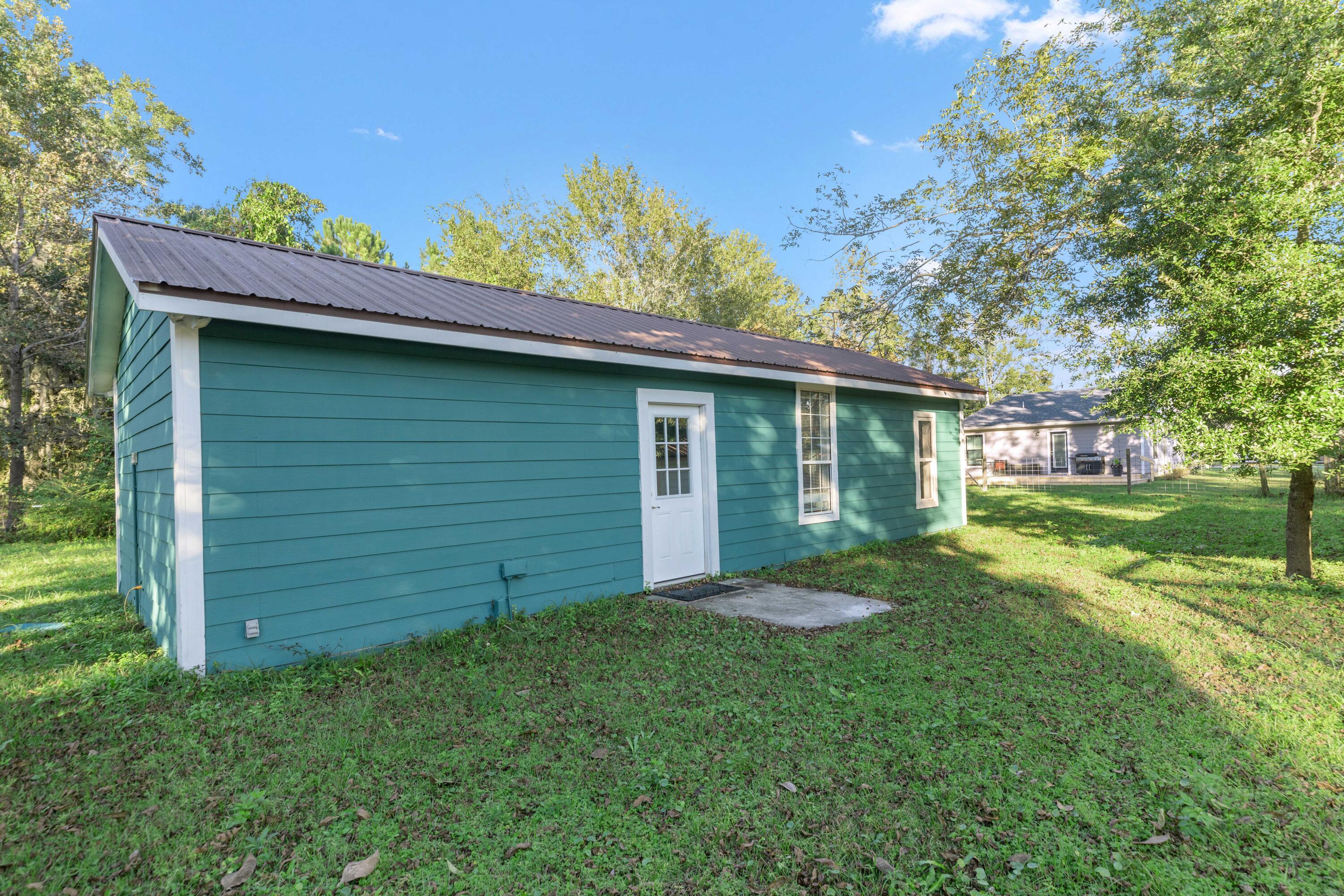 229 Madison Street Freeport, FL 32439 - Photo 35 of 44 a view of a backyard with a garden
