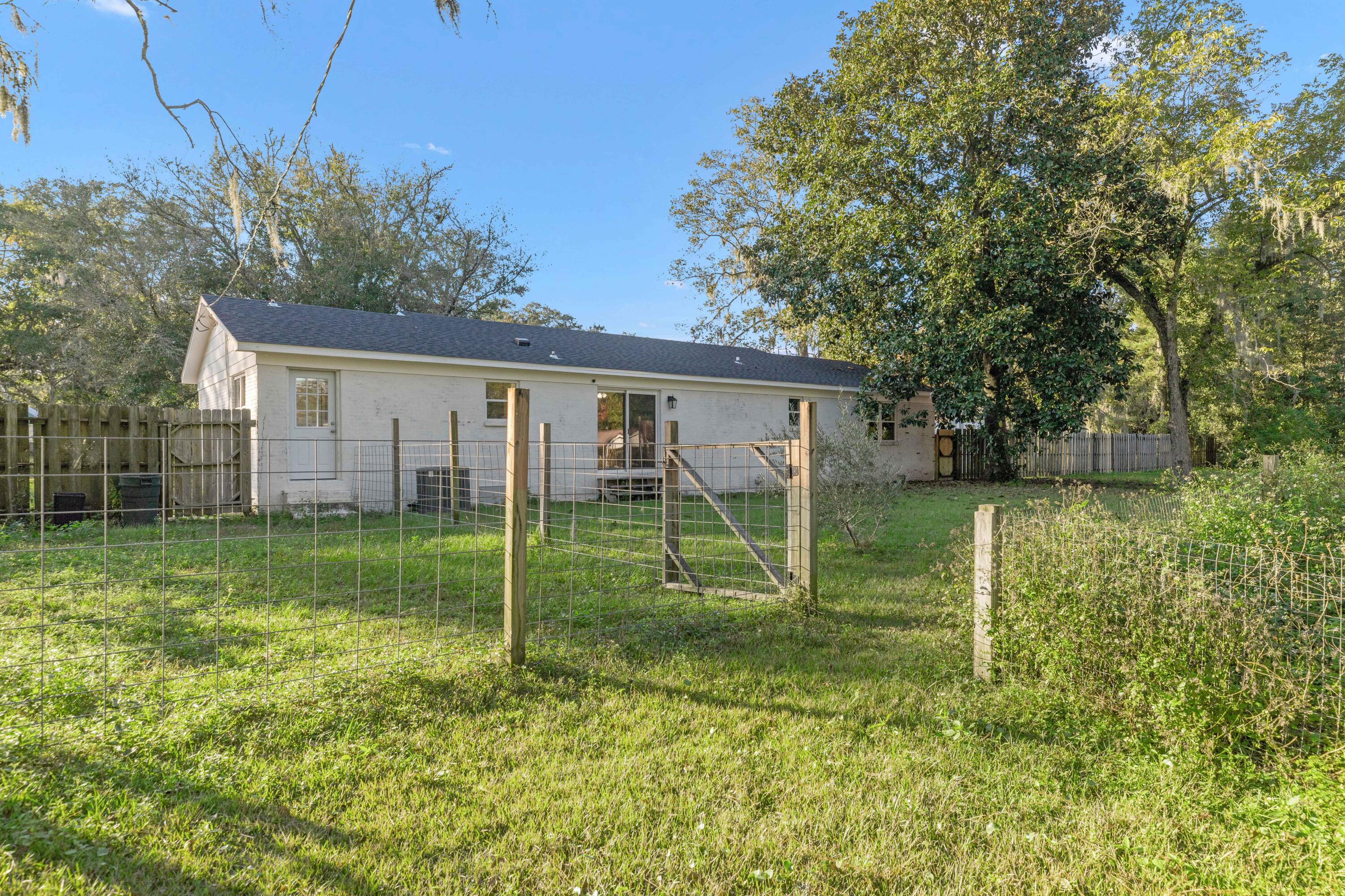 229 Madison Street Freeport, FL 32439 - Photo 40 of 44 a view of a house with backyard and a tree