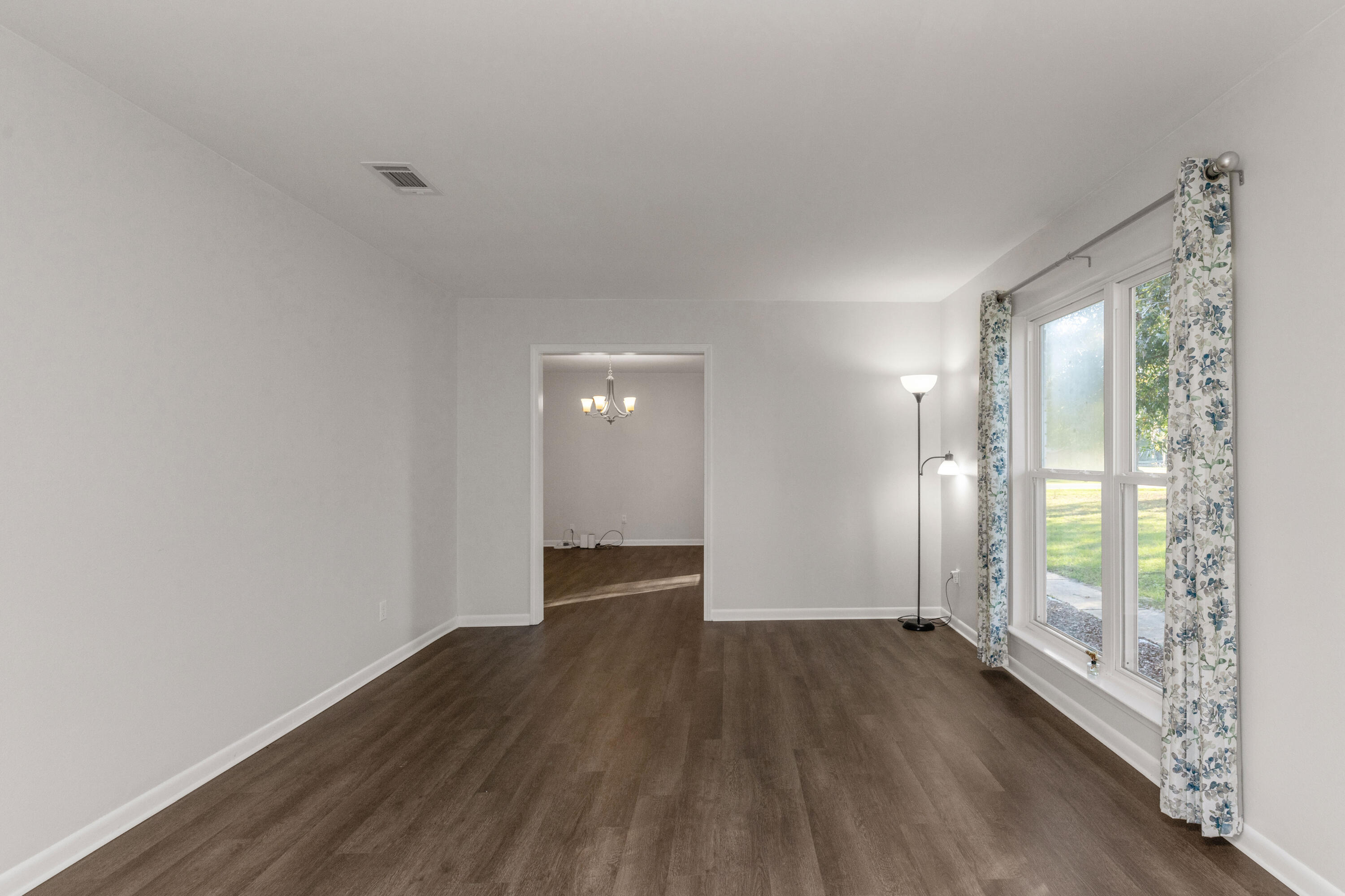 229 Madison Street Freeport, FL 32439 - Photo 5 of 44 an empty room with wooden floor and windows