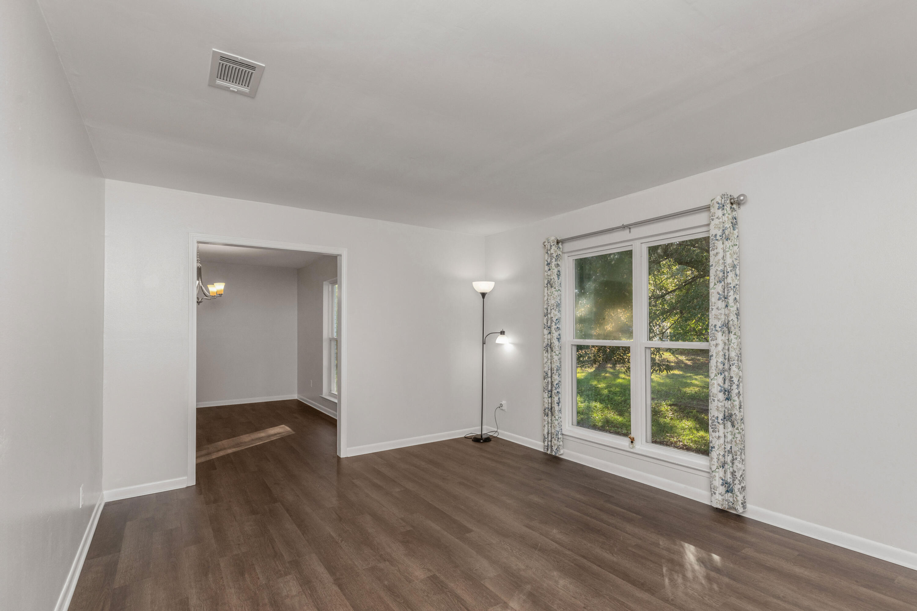 229 Madison Street Freeport, FL 32439 - Photo 6 of 44 an empty room with wooden floor and windows