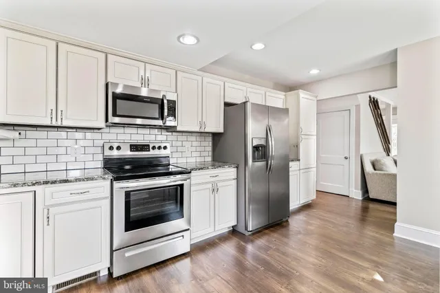 a kitchen with stainless steel appliances a refrigerator stove and microwave