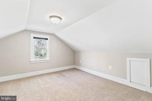 an empty room with a empty space and windows