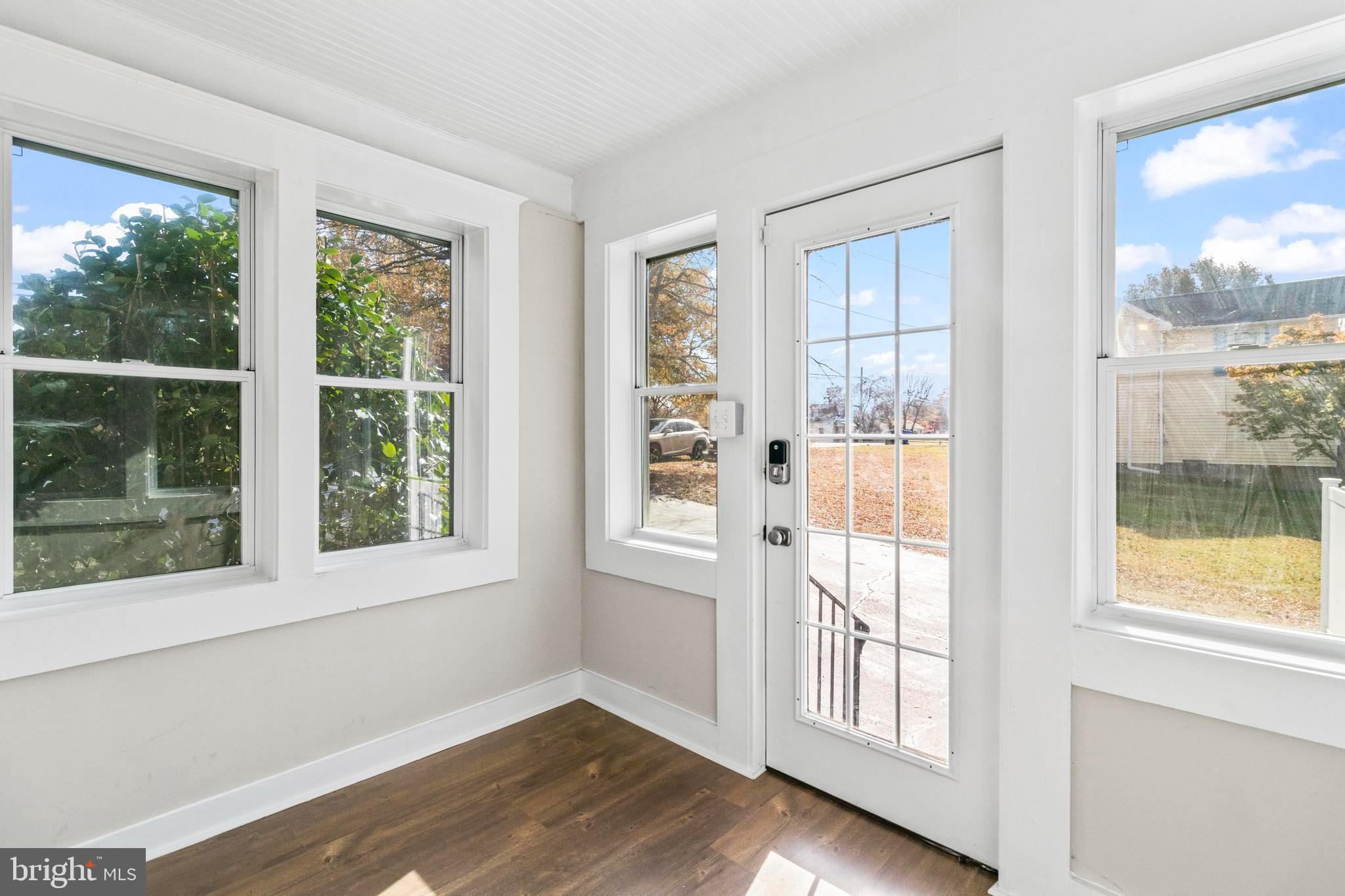 9005 Fairground Road Bel Alton, MD 20611 - Photo 21 of 54 a view of an empty room with wooden floor and a window