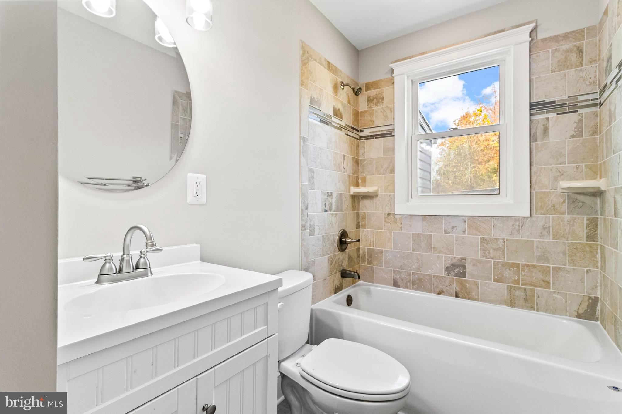9005 Fairground Road Bel Alton, MD 20611 - Photo 23 of 54 a bathroom with a sink a toilet a tub and a mirror