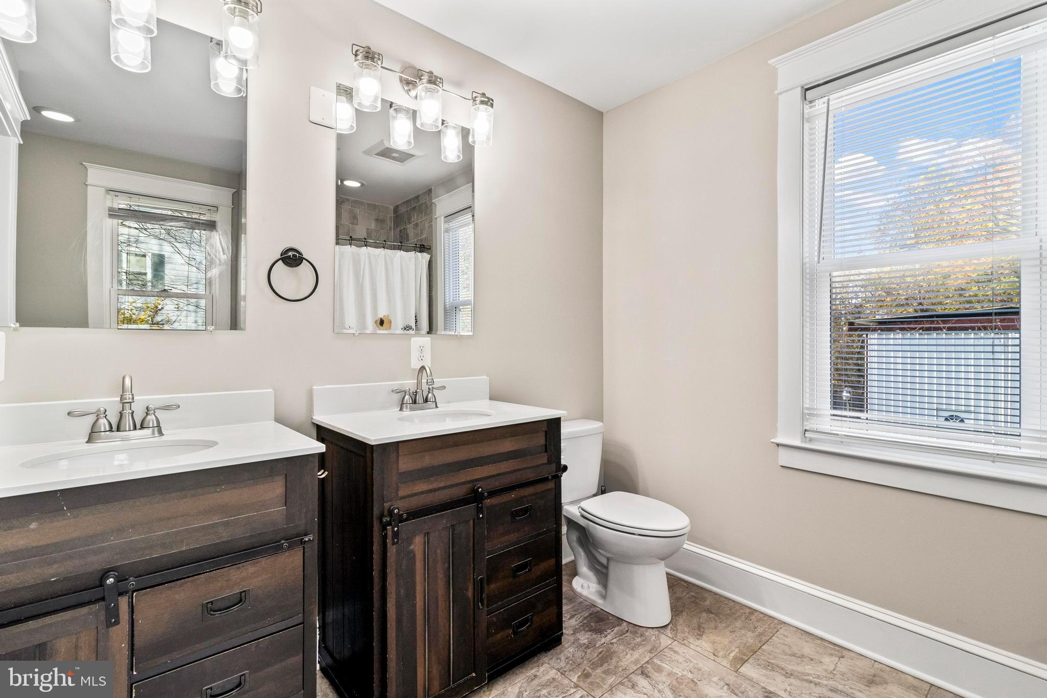 9005 Fairground Road Bel Alton, MD 20611 - Photo 28 of 54 a bathroom with a sink a toilet and a mirror
