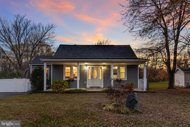a front view of house with a garden