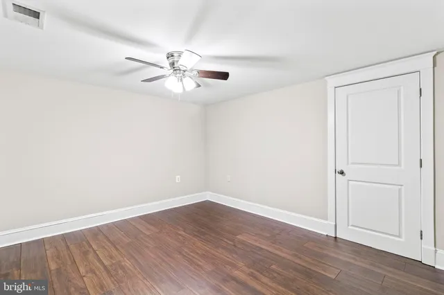 a bathroom with a granite countertop toilet a sink and a mirror
