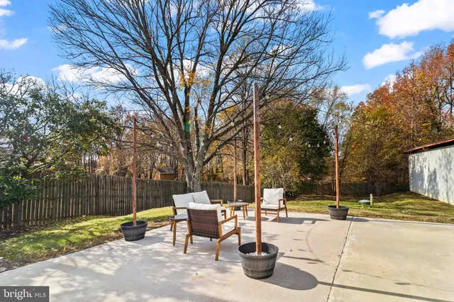 a front view of a house with a garden and trees
