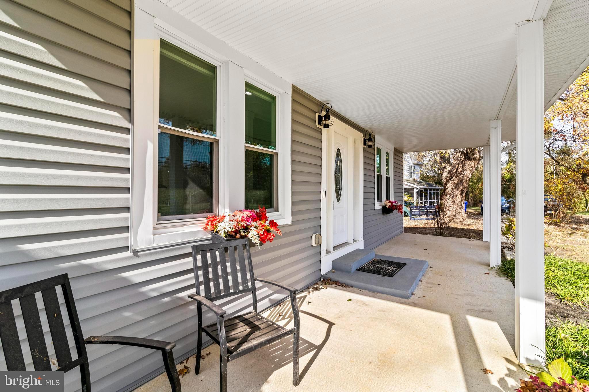 9005 Fairground Road Bel Alton, MD 20611 - Photo 41 of 54 a patio with table and chairs and potted plants