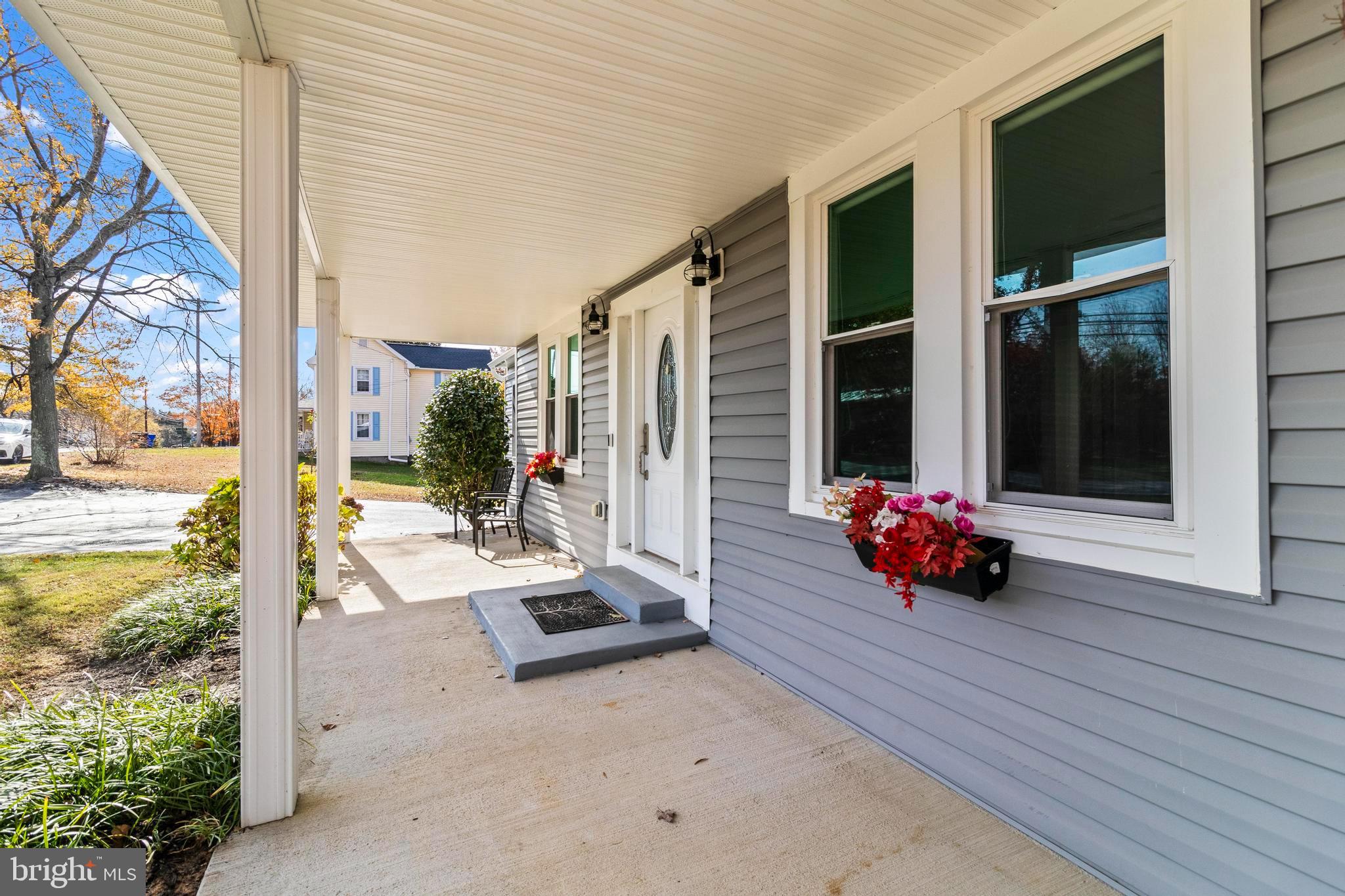 9005 Fairground Road Bel Alton, MD 20611 - Photo 42 of 54 a view of a porch with furniture and floor to ceiling window