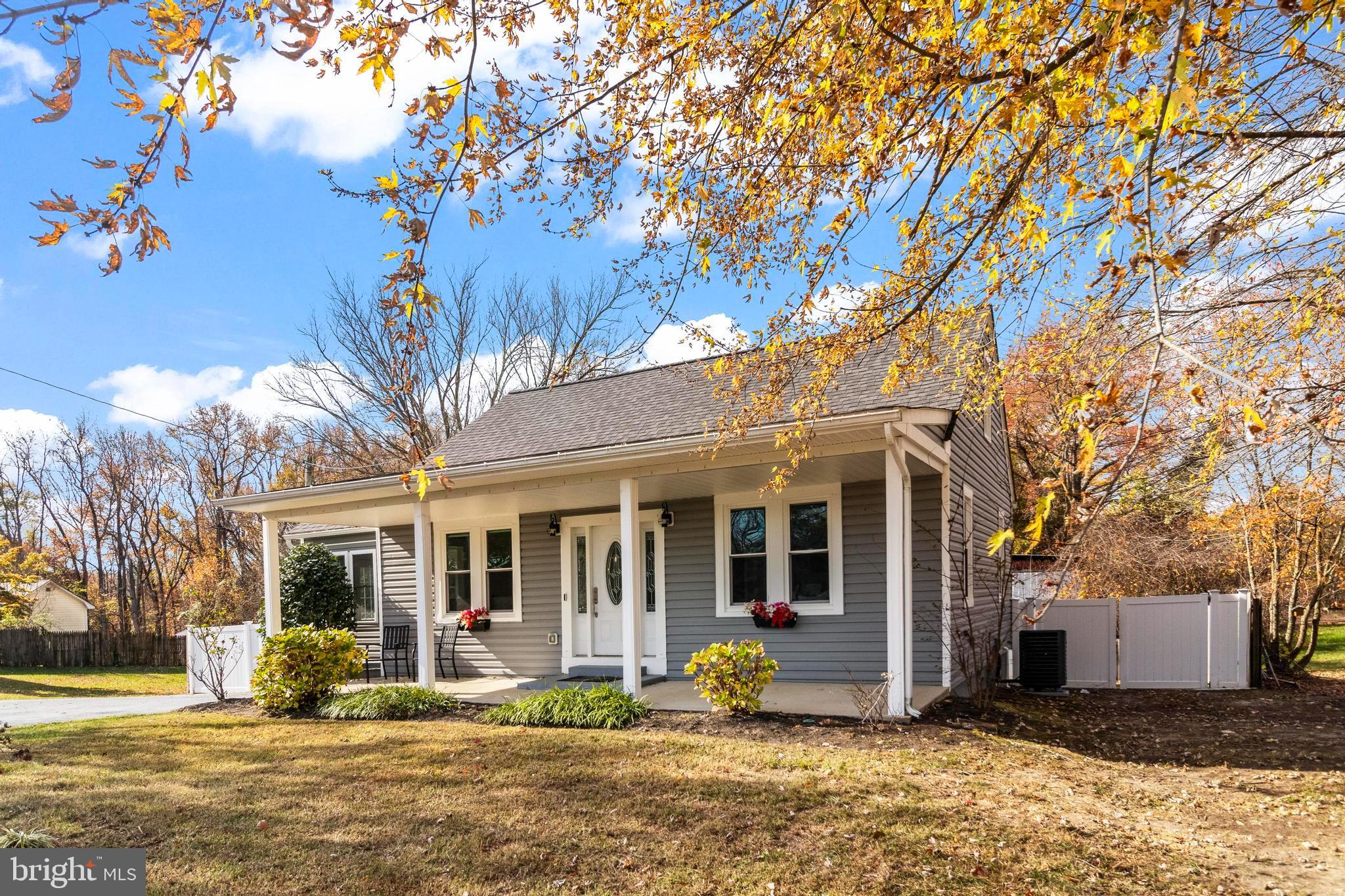 9005 Fairground Road Bel Alton, MD 20611 - Photo 43 of 54 a front view of a house with a large tree in front