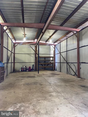 a view of an empty room with yard and garage