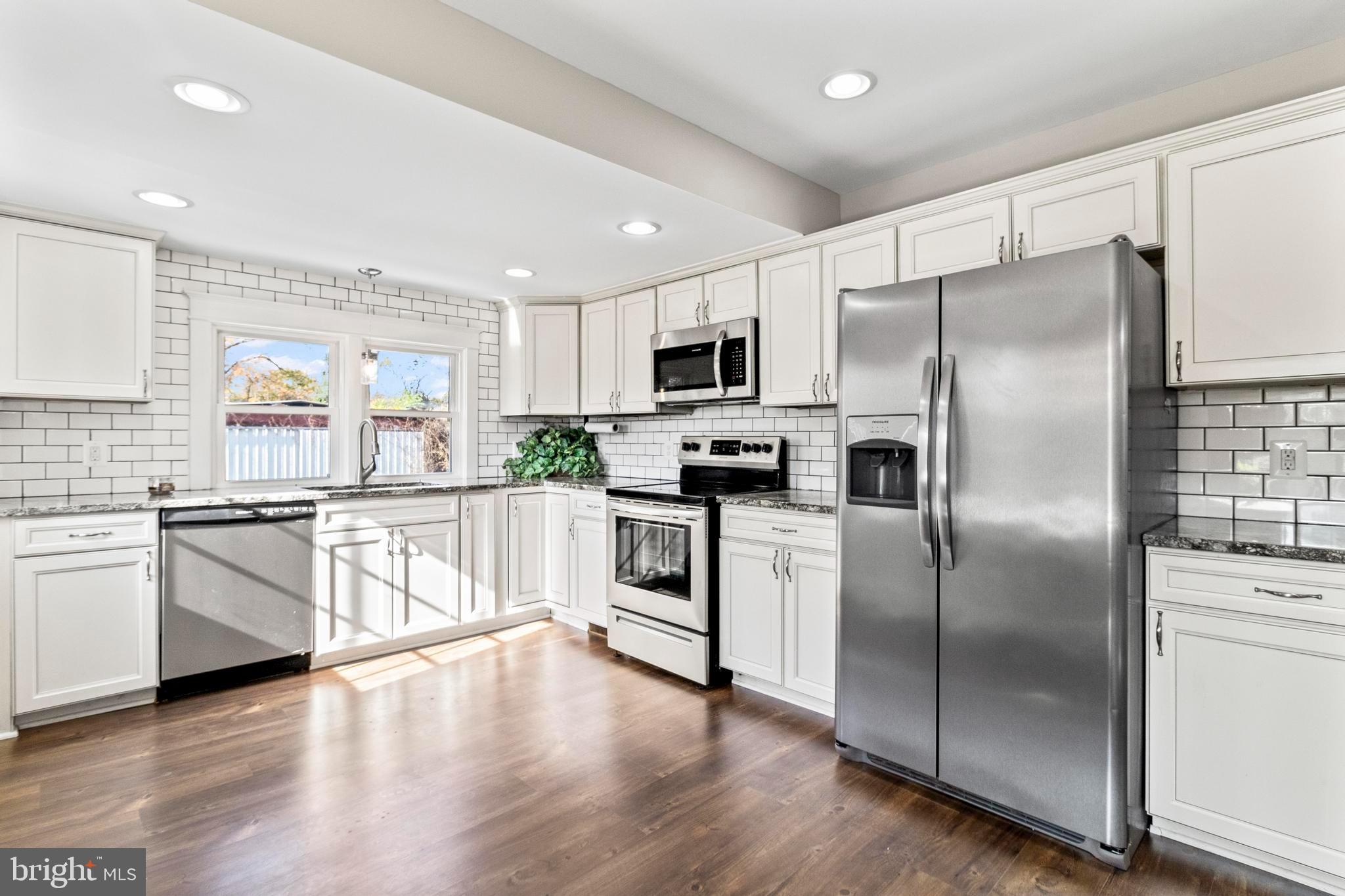 9005 Fairground Road Bel Alton, MD 20611 - Photo 8 of 54 a kitchen with white cabinets stainless steel appliances and a window