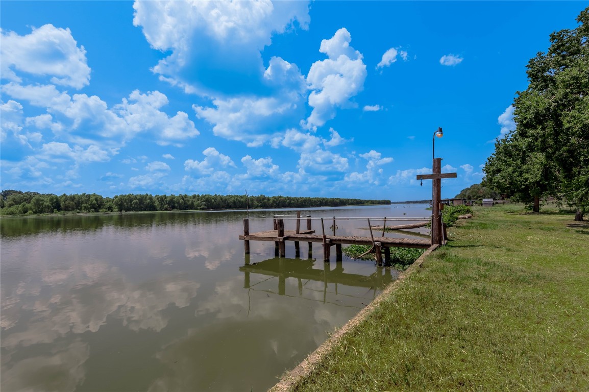 206 Lake Front Drive Trinity, TX 75862 - Photo 13 of 48 a view of a lake in between two chairs and a table