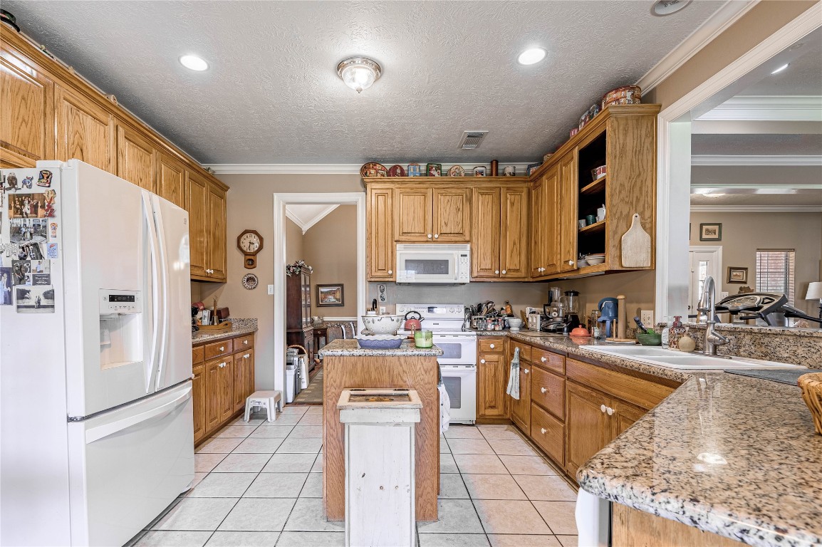 206 Lake Front Drive Trinity, TX 75862 - Photo 22 of 48 a kitchen with stainless steel appliances granite countertop a refrigerator and a stove top oven