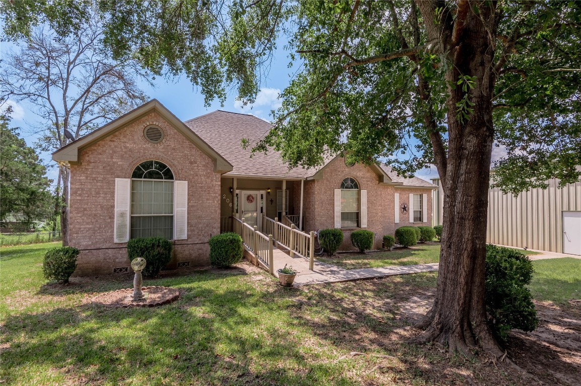 206 Lake Front Drive Trinity, TX 75862 - Photo 3 of 48 a front view of a house with garden