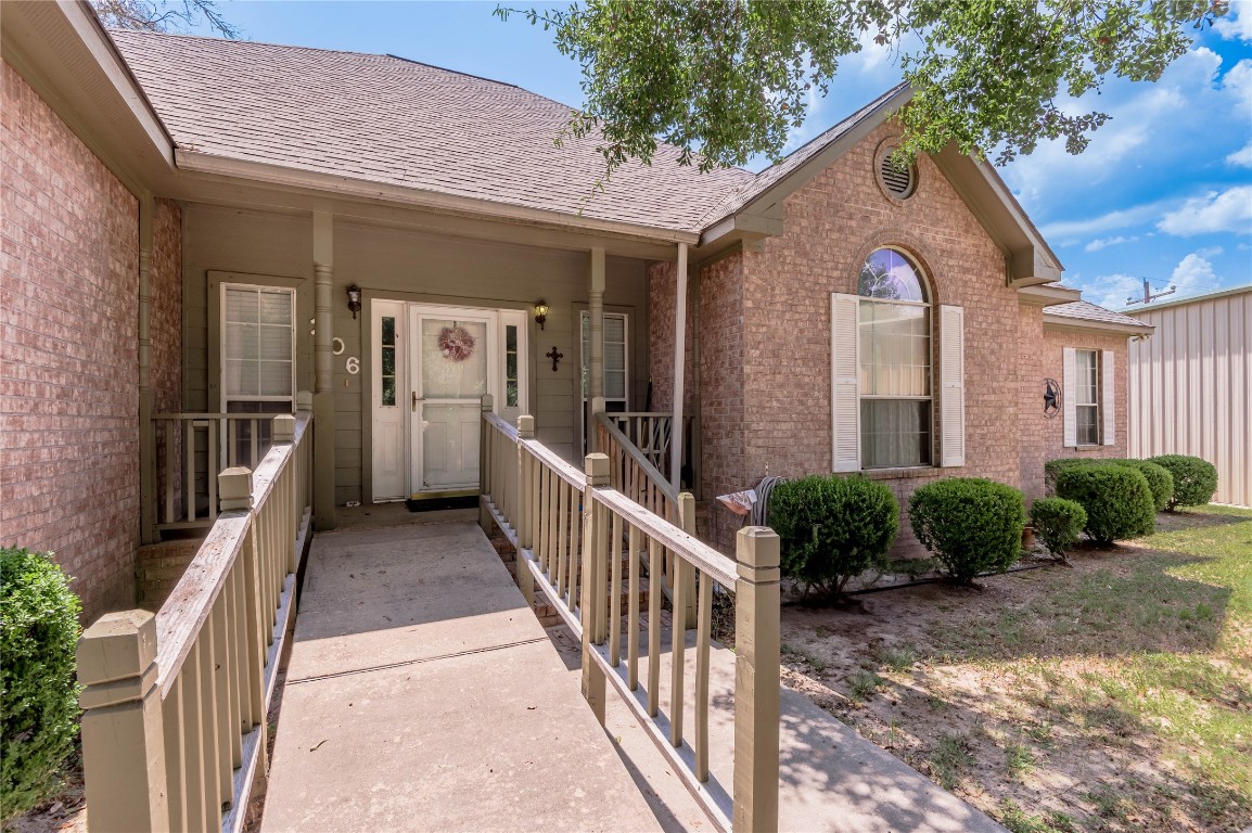 206 Lake Front Drive Trinity, TX 75862 - Photo 4 of 48 a view of a house with brick walls and a yard