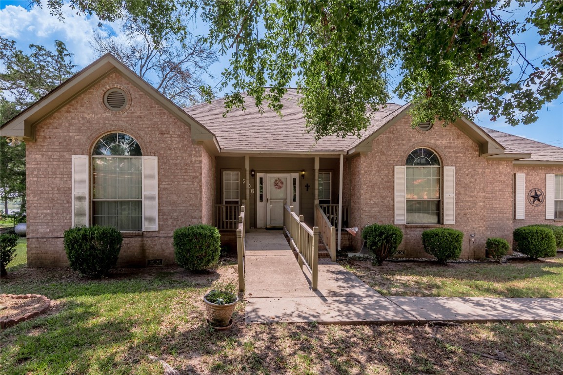 206 Lake Front Drive Trinity, TX 75862 - Photo 5 of 48 a front view of a house with garden