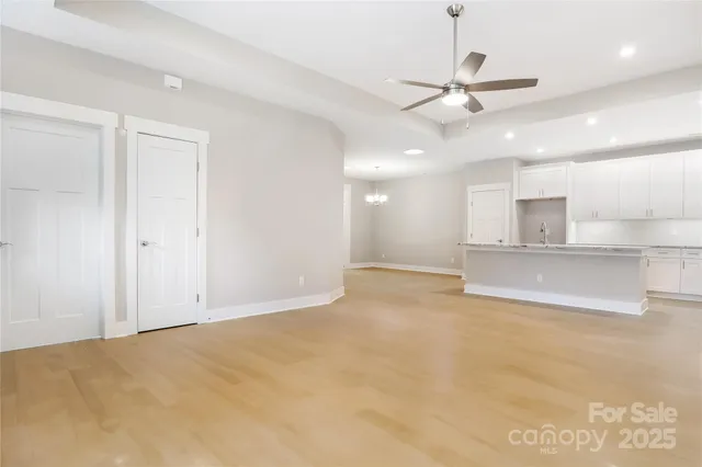 a view of a kitchen with a sink and a refrigerator