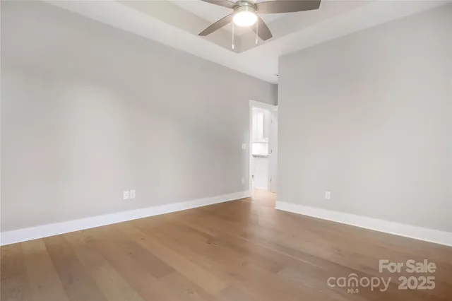 an empty room with a empty space and a ceiling fan