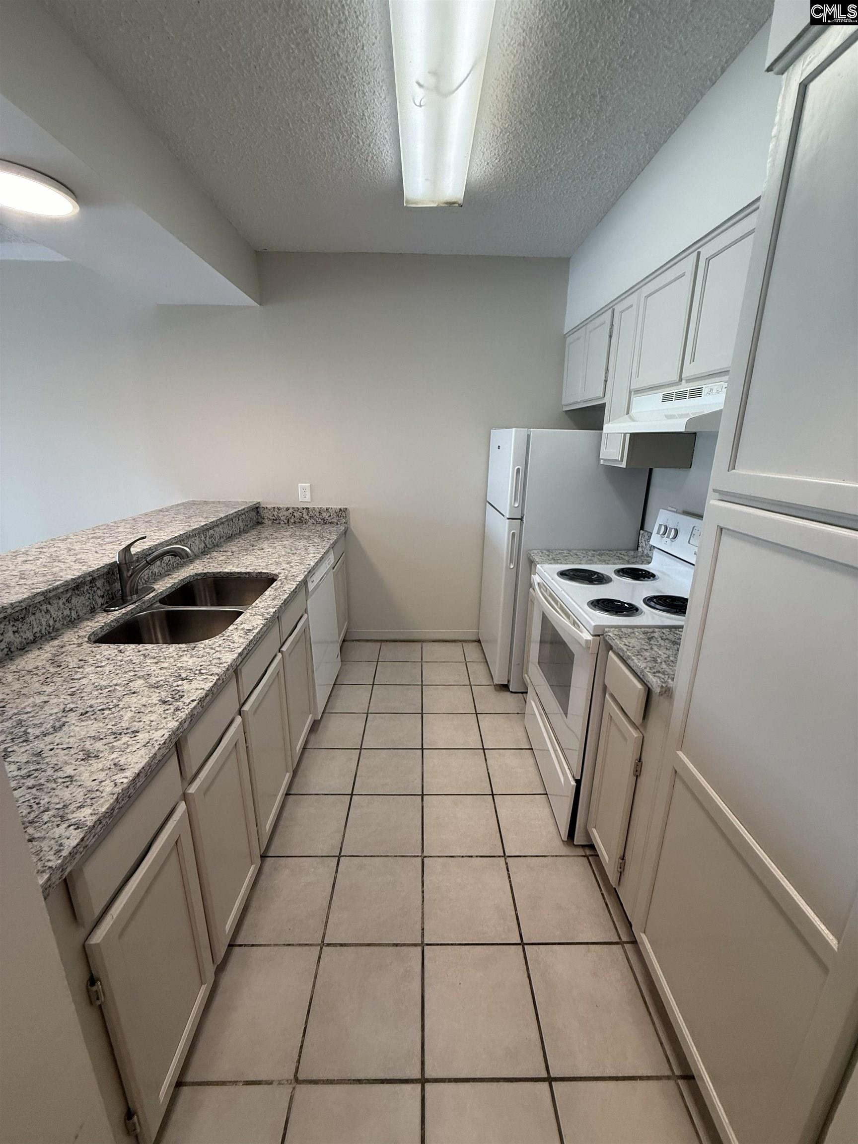 2002 Greene Street, Unit 209 Columbia, SC 29205 - Photo 15 of 22 a kitchen with a sink a stove and cabinets