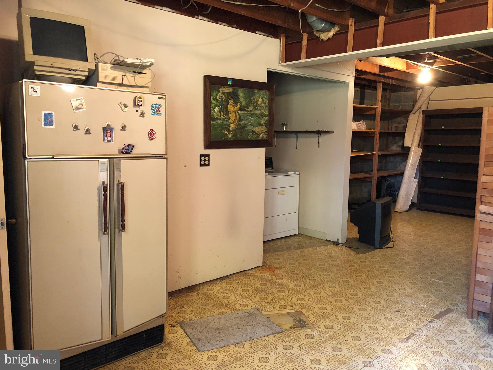 16031 Riffle Ford Road Gaithersburg, MD 20878 - Photo 16 of 23 a view of storage and utility room with refrigerator