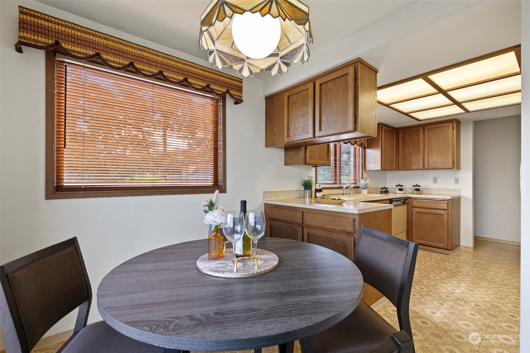 411 Seneca Court Northwest Renton, WA 98057 - Photo 13 of 37 a kitchen with a dining table and chairs
