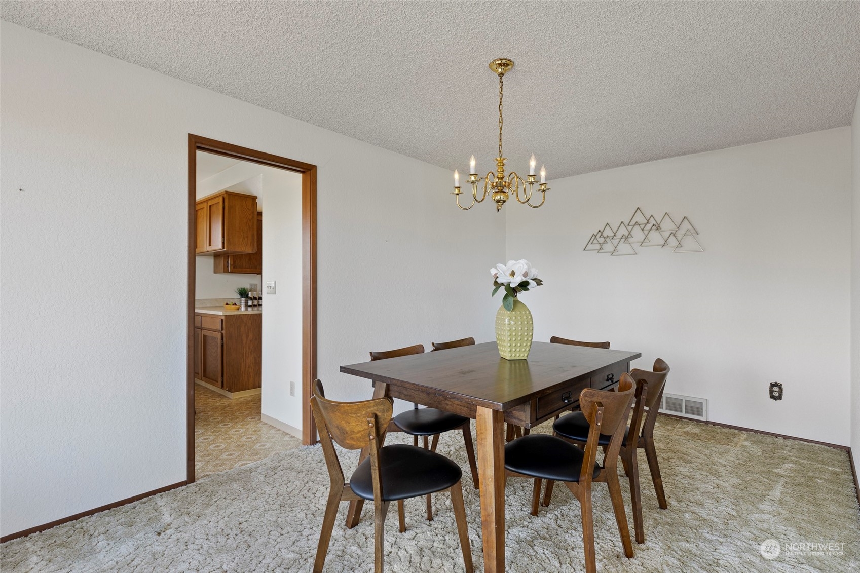 411 Seneca Court Northwest Renton, WA 98057 - Photo 19 of 37 a view of a dining room with furniture and chandelier