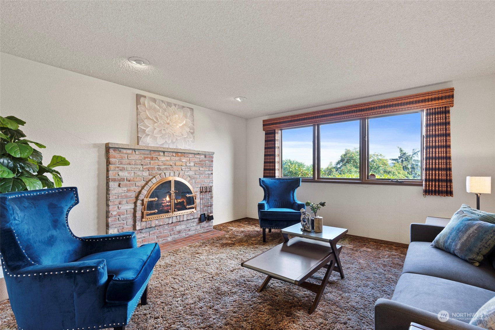 411 Seneca Court Northwest Renton, WA 98057 - Photo 26 of 37 a living room with furniture a fireplace and a potted plant