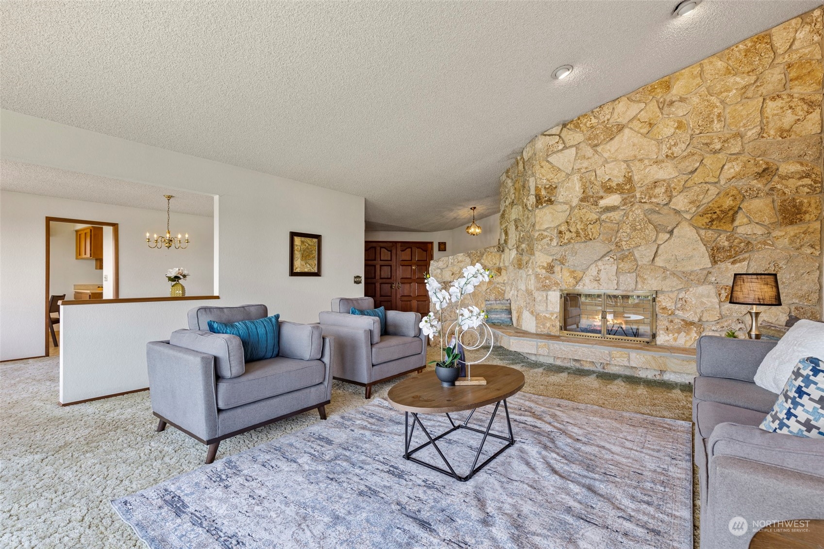 411 Seneca Court Northwest Renton, WA 98057 - Photo 7 of 37 a living room with fireplace furniture and a table