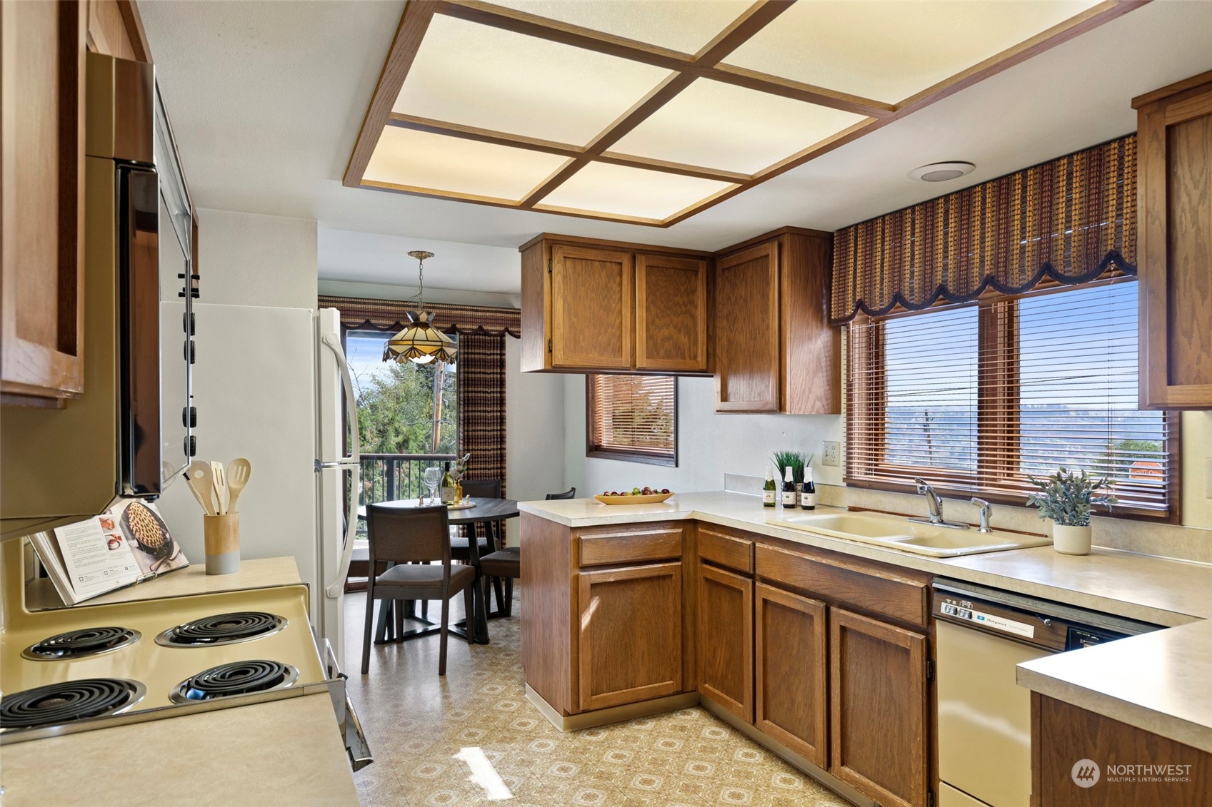 411 Seneca Court Northwest Renton, WA 98057 - Photo 8 of 37 a kitchen with a sink stove and cabinets