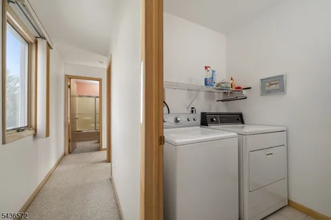 a view of a hallway with wooden floor and stairs