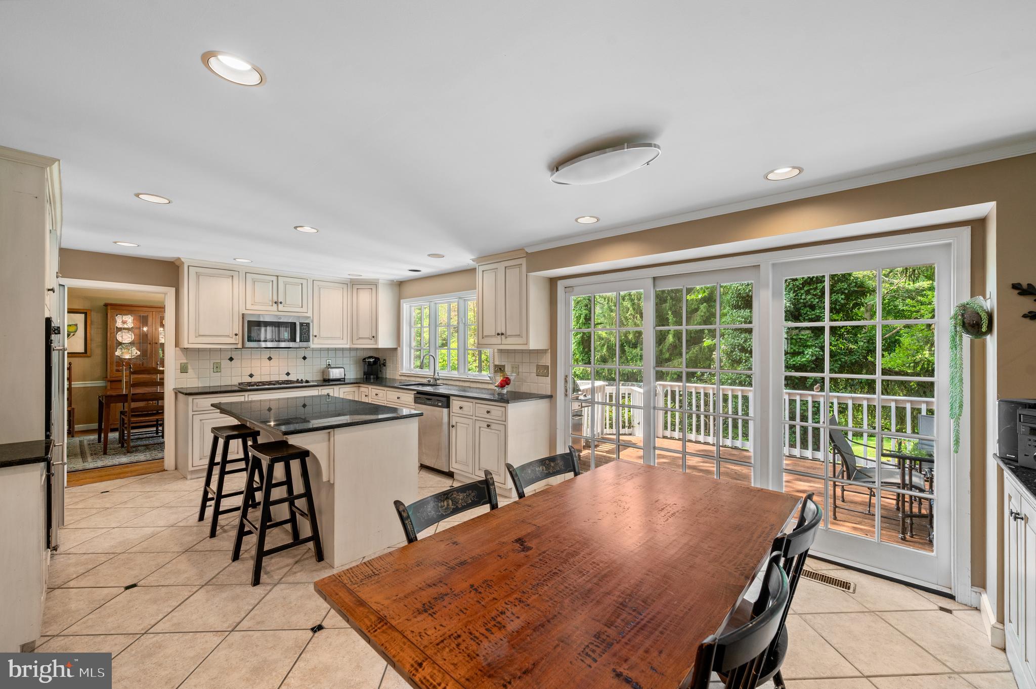 211 Spruce Tree Road Wayne, PA 19087 - Photo 13 of 44 a kitchen with stainless steel appliances granite countertop a stove a sink a refrigerator dining table and chairs
