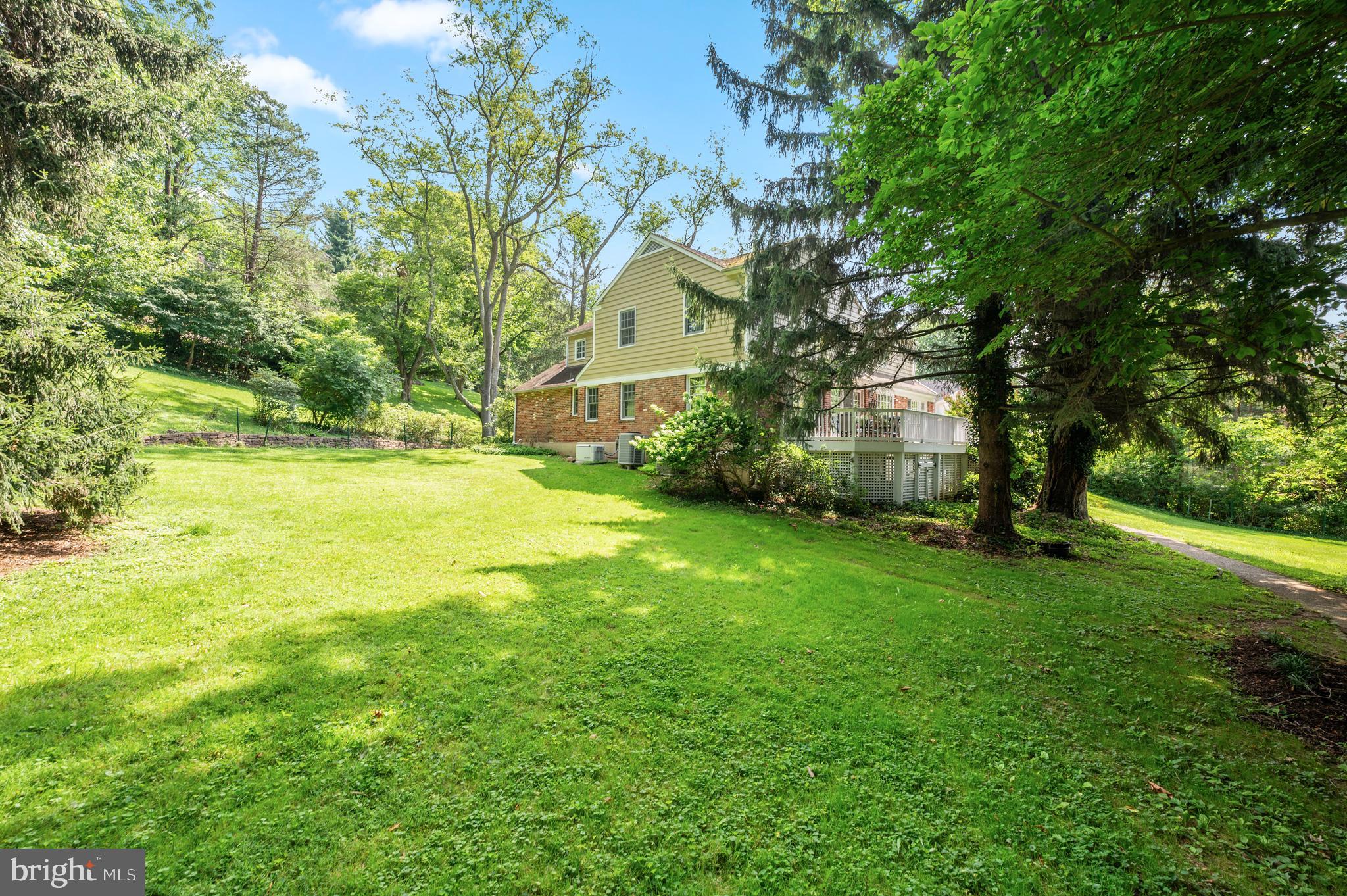 211 Spruce Tree Road Wayne, PA 19087 - Photo 41 of 44 a backyard of a house with plants and large trees