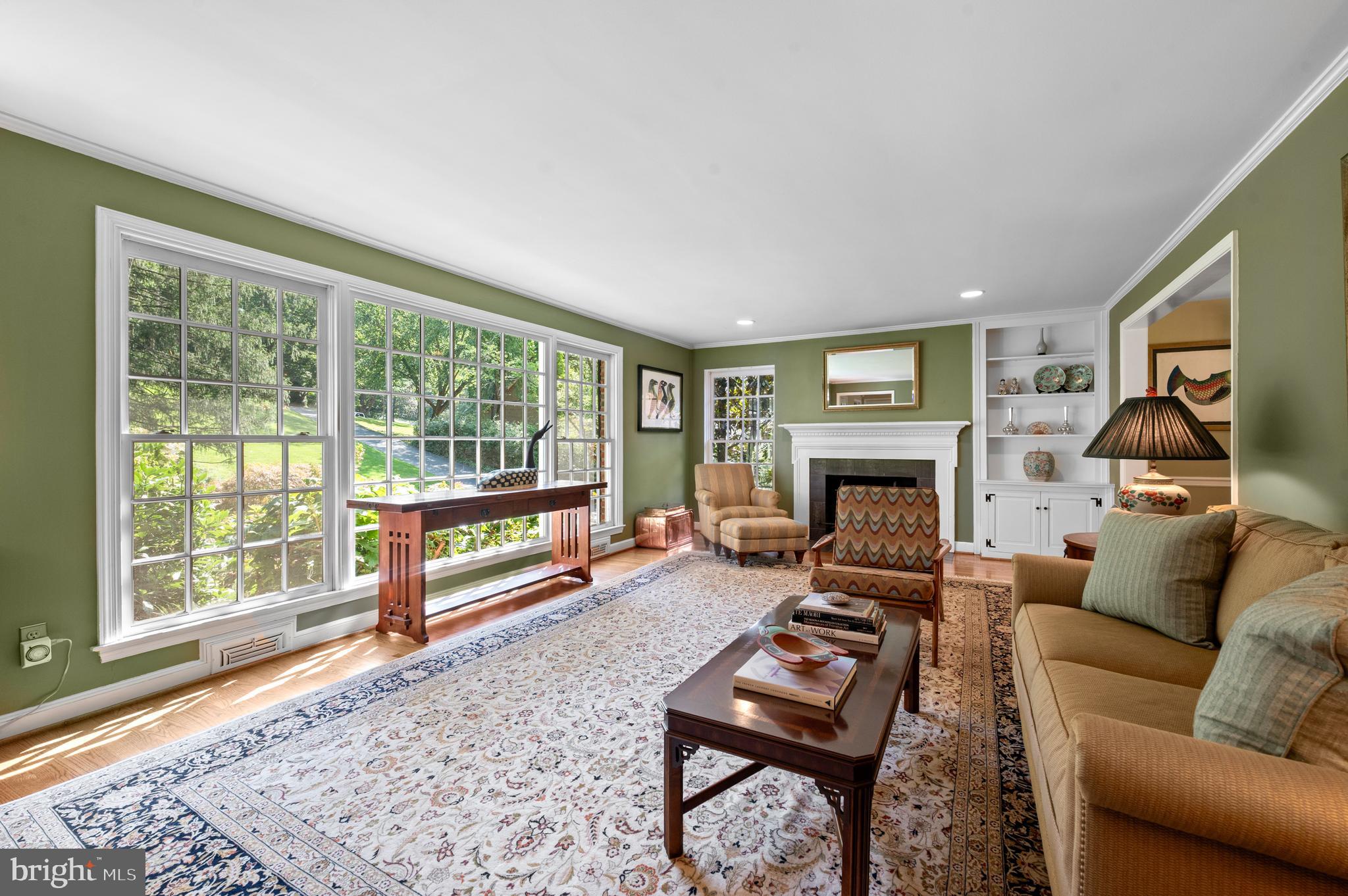 211 Spruce Tree Road Wayne, PA 19087 - Photo 5 of 44 a living room with furniture a flat screen tv and a fireplace