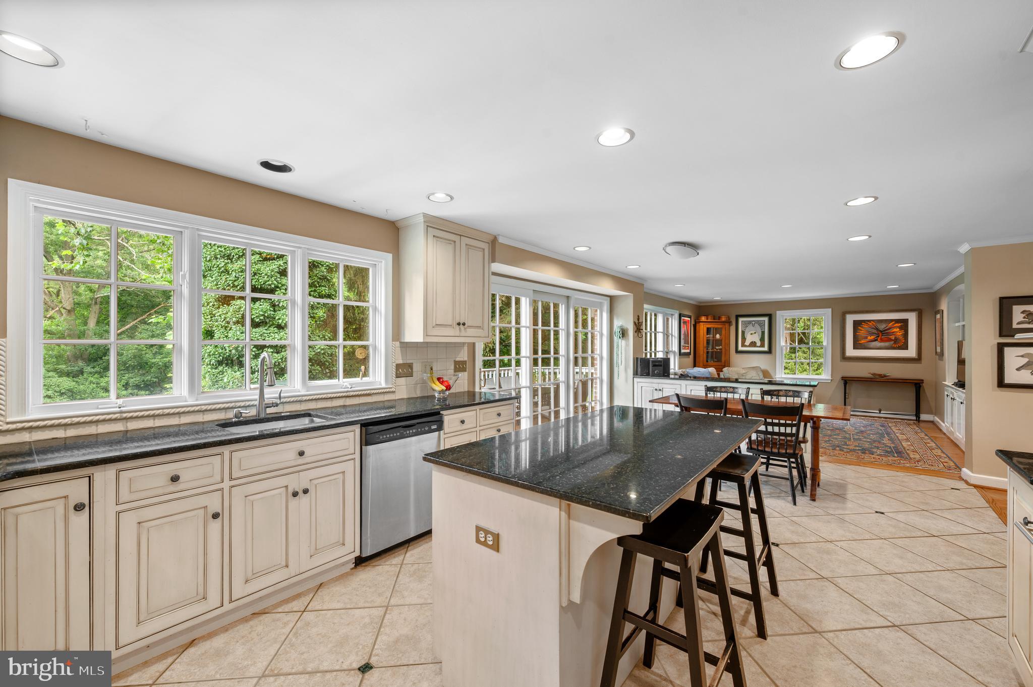 211 Spruce Tree Road Wayne, PA 19087 - Photo 9 of 44 a kitchen with stainless steel appliances granite countertop a stove top oven a sink a dining table and chairs