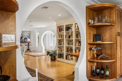 a living room with furniture a flat screen tv and a dining table