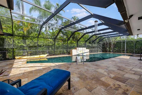 an aerial view of residential houses with outdoor space and trees