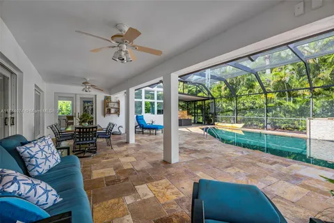 an aerial view of residential houses with outdoor space and trees
