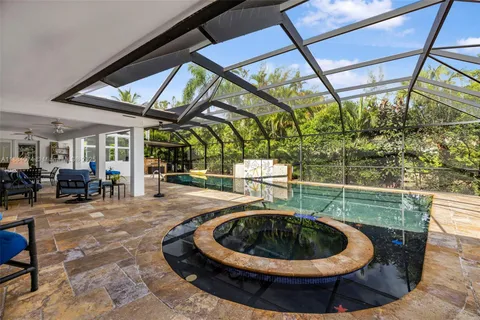 an aerial view of a house with a yard basket ball court and outdoor seating