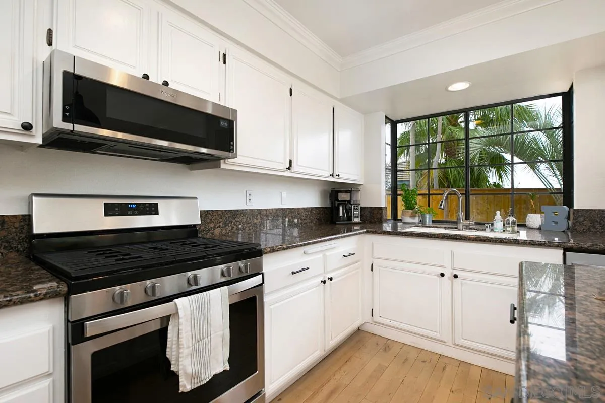 1265 Longfellow Road Vista, CA 92081 - Photo 11 of 28 a kitchen with stainless steel appliances granite countertop a stove and a microwave
