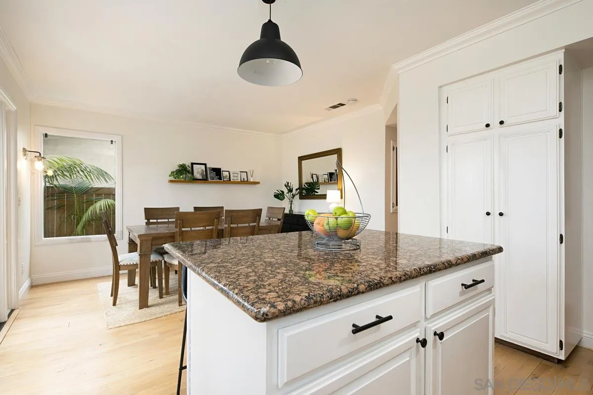 1265 Longfellow Road Vista, CA 92081 - Photo 12 of 28 a kitchen with stainless steel appliances granite countertop a sink and a refrigerator